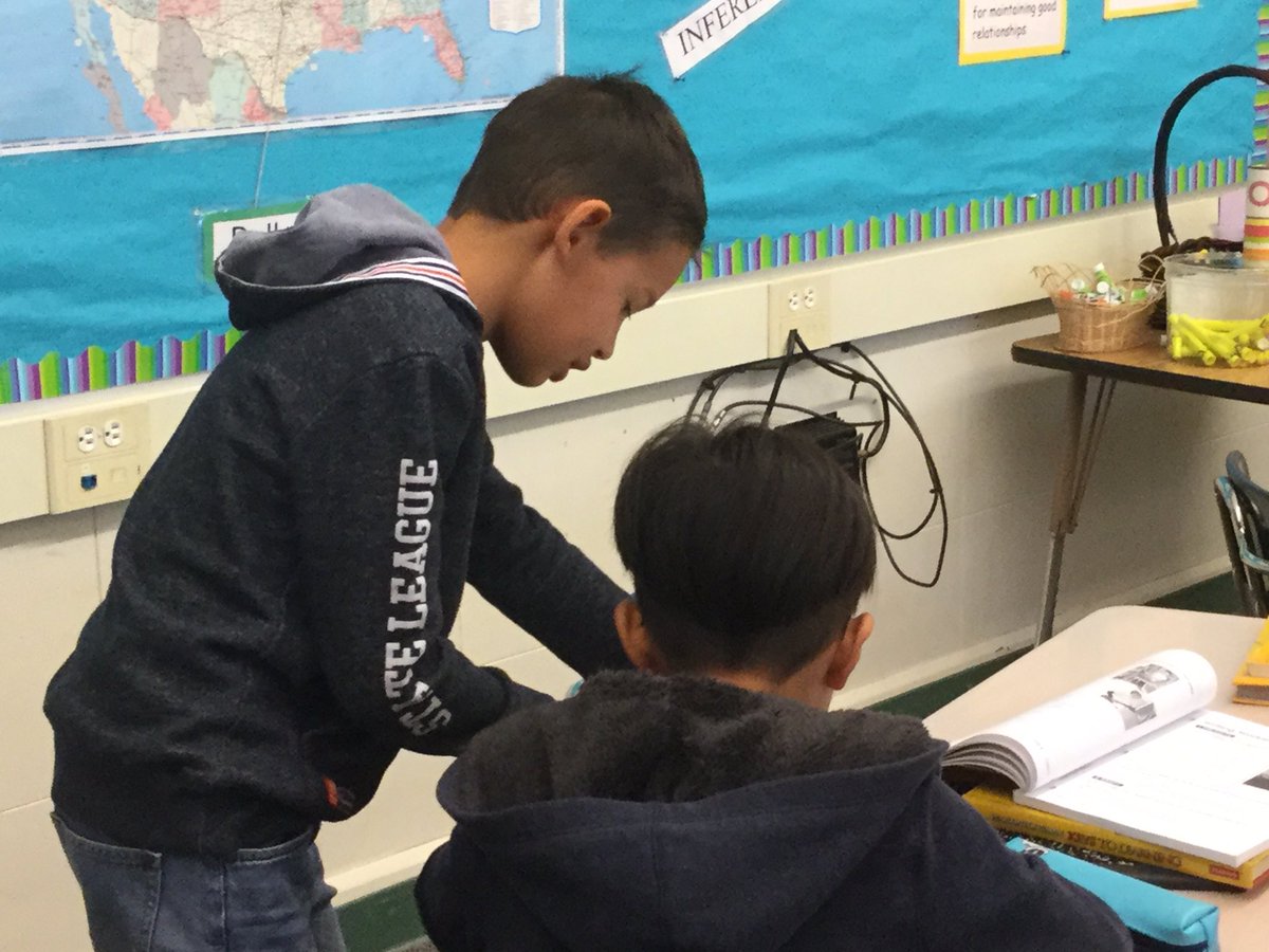 wcfilly's tweet photo. October is the time when our ELD students become comfortable with communicating in English. This is our newest English speaker helping a classmate with his homework. My heart is happy!#wci_eld https://t.co/ZW0OkkrY1q