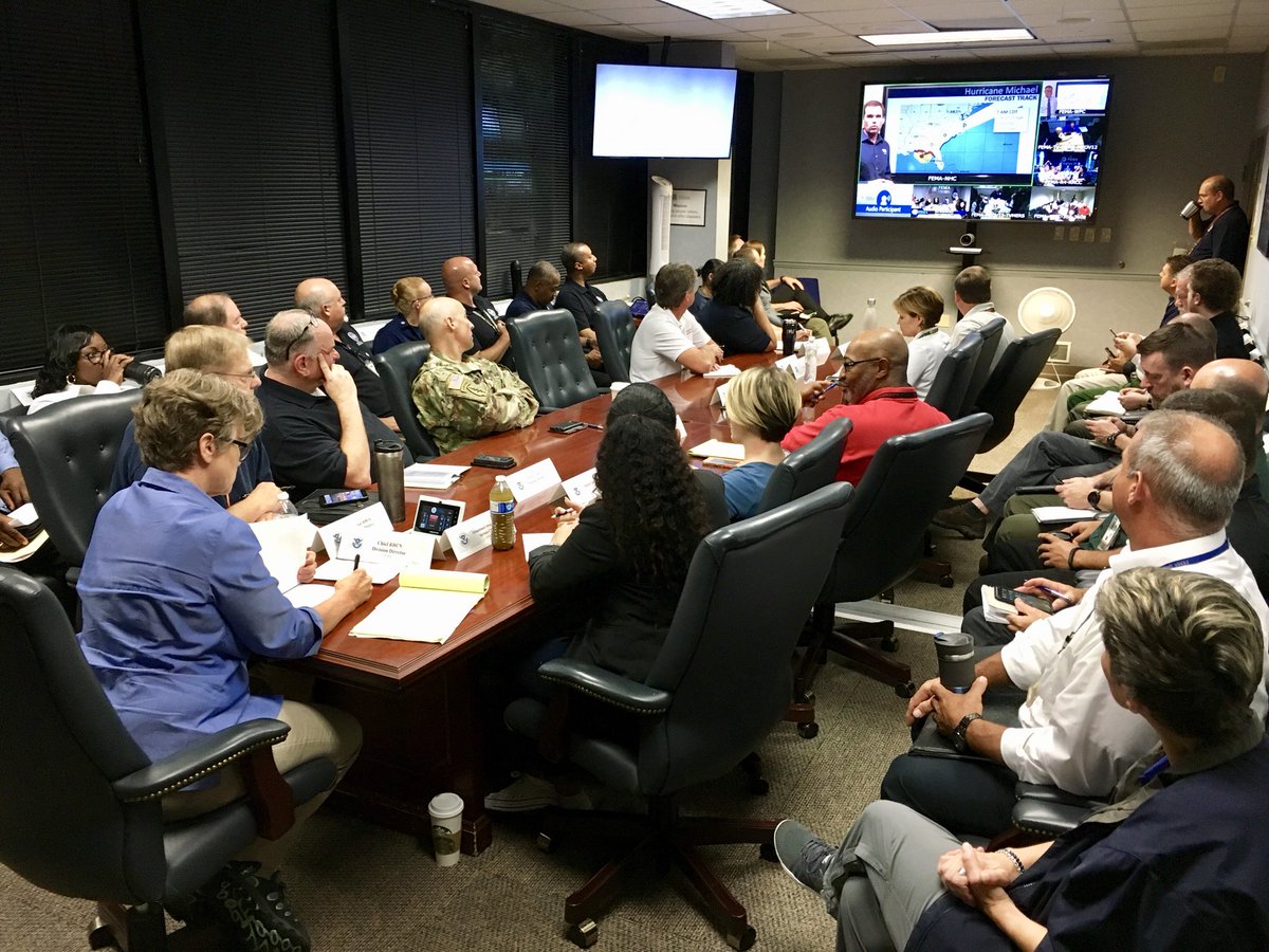 A packed conference room full of FEMA staffers and military partners participating on a conference call.