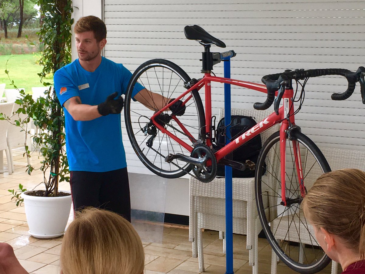 NeilsonBaia's tweet photo. A few showers first thing #thismorning so #Bike Coordinator Toby, offers a in-depth repair clinic for #roadbikes #Trek #Emonda at our #Pool Bar ...meanwhile our #mountainbikers are out enjoying the puddles in the trails @neilsonholidays https://t.co/UDBUrQwAfz