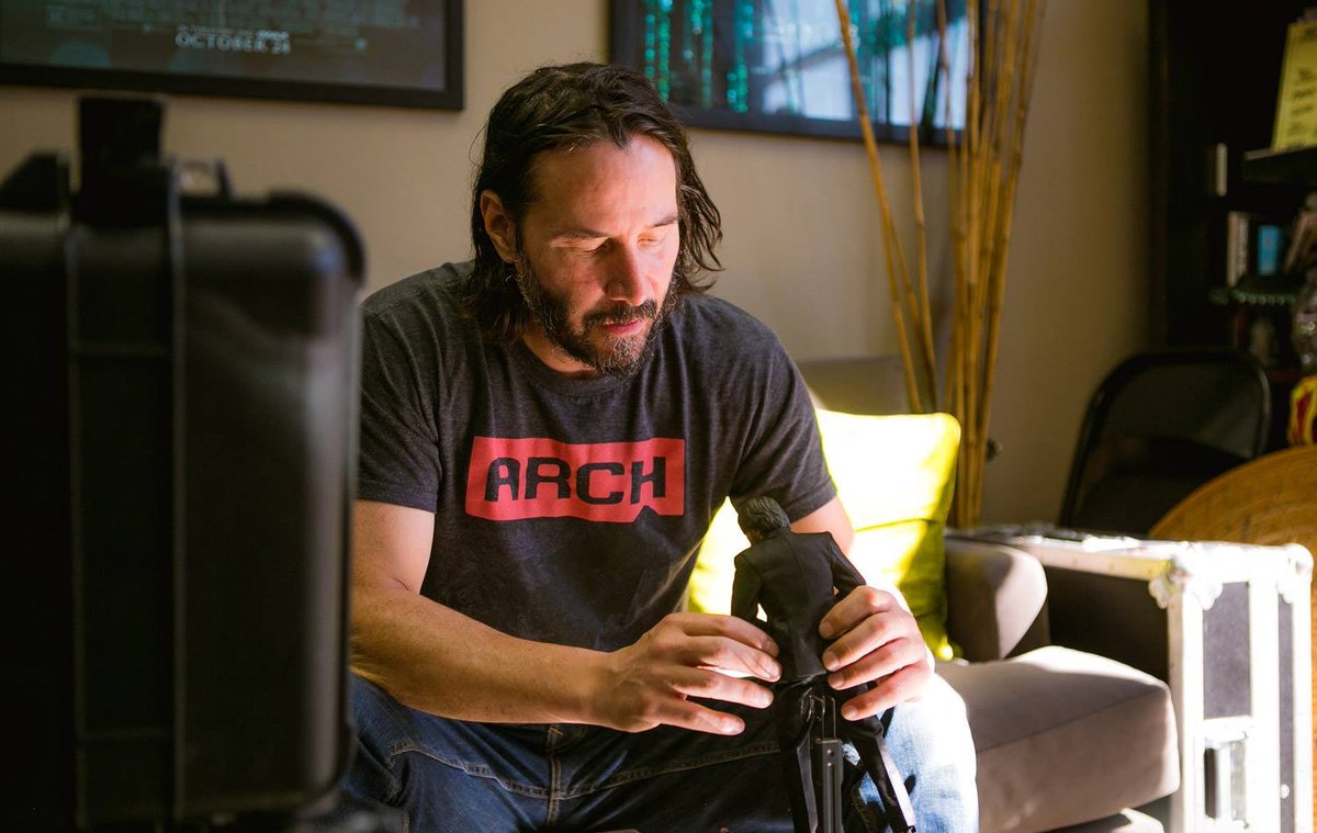 keanuthings's tweet photo. keanu reeves playing with an action figure of himself https://t.co/aqQILOBha3