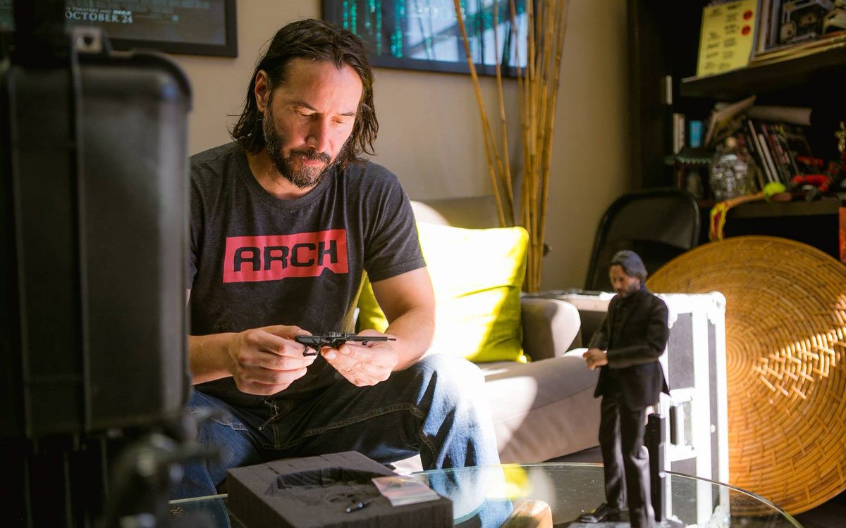 keanuthings's tweet photo. keanu reeves playing with an action figure of himself https://t.co/aqQILOBha3