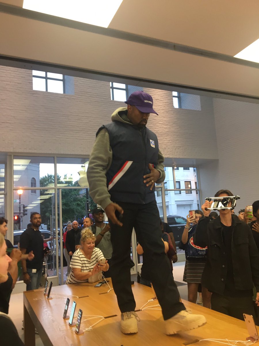 FeitsBarstool's tweet photo. Kanye jumped on a table to give a speech at an Apple Store and it’s the second most asshole thing happening in the picture https://t.co/6VOzx4Zwfv