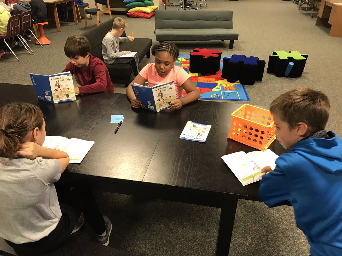 Students are reading a drama while focusing on finding the theme!