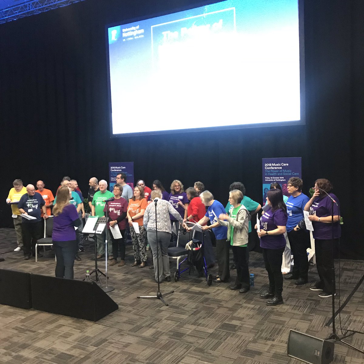InstituteMH's tweet photo. We’re delighted to welcome the #NottinghamPeoplesChoir next to perform for us - a community choir for health & wellbeing for all its members.... warming those vocal chords up nicely 🎶 https://t.co/l5sza9lXpT