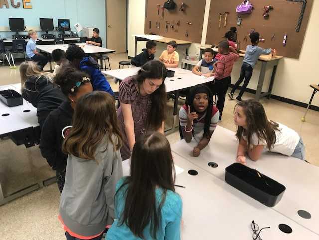 Tech_CoachLloyd's tweet image. Ms. Messex and her students are working hard in the Makerspace.