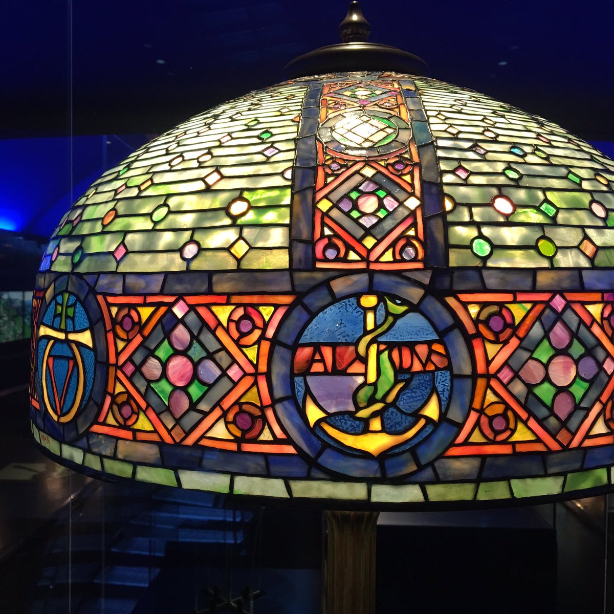 pinwheel_press's tweet photo. Bonus: a Tiffany lamp with printers’ marks! @nyhistory believes this Bookmark shade was a special commission for a book collector’s library. #printersmarks #Tiffanylamp #TiffanyGlass #AldusManutius https://t.co/d9HdI2ZQhs