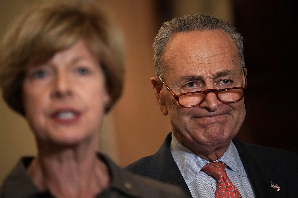 Sen. Tammy Baldwin speaks as Senate Minority Leader Chuck Schumer listens during a news briefing after a weekly Senate Democratic policy luncheon, October 10, 2018, in Washington, DC.