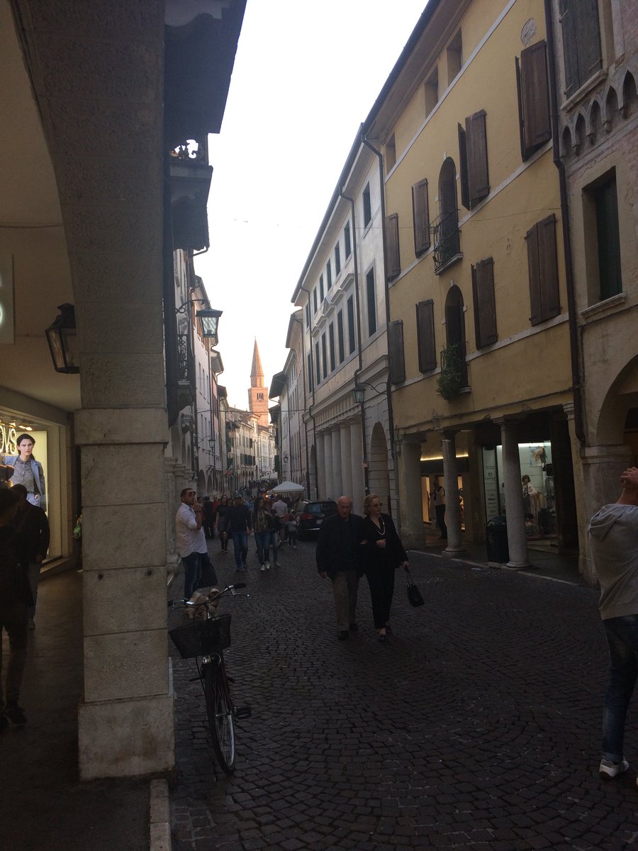 best2vilmabanky's tweet photo. Late afternoon sun hits the southern end of Pordenone’s old high street where local folk like to perambulate. A courtyard we wandered into where the launch of a hemp shop was being celebrated! #GCM37 https://t.co/yrHYDYuaDe
