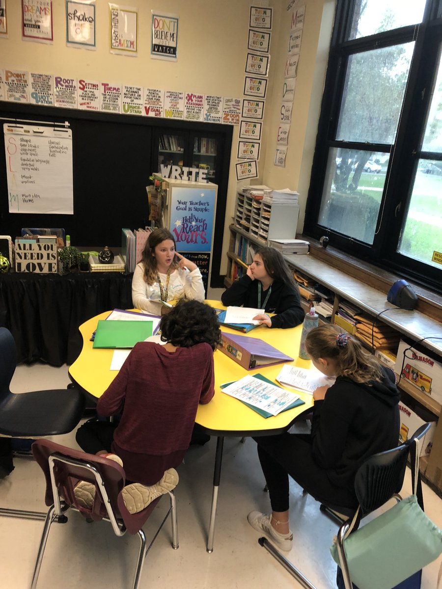 MsGisWRITEhere's tweet photo. How do our growing writers analyze poetry? They SLAM 'em, looking for structure, language, affect, and meaning! Here are our students, partnered up, slammin' a poem of their choice during the close-out of Immersion! https://t.co/QnNLK7aN6e