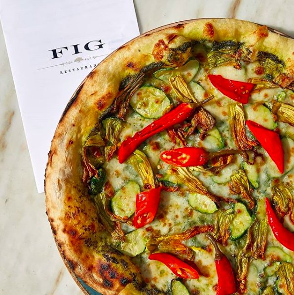 Is it still a pizza party if you eat it all yourself? Our Squash Blossom Pizza is a delightful take on the classic veggie option taken up a notch with green garlic pesto and chiles. #figsantamonica