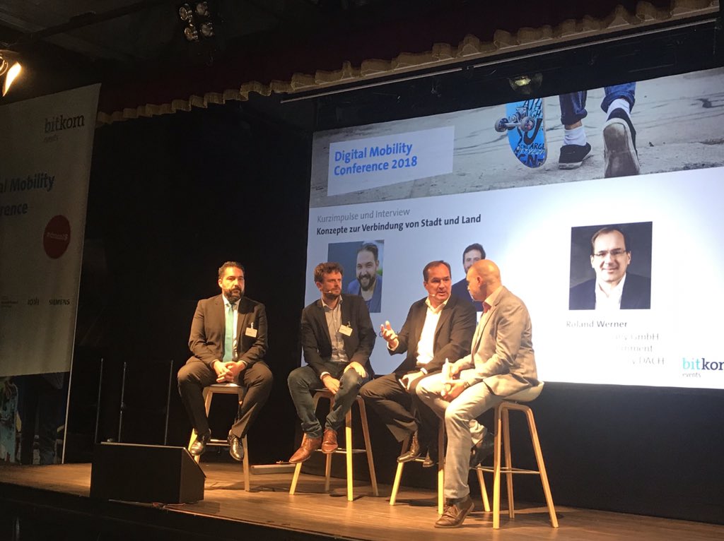 Bitkom_Mobility's tweet photo. Ahmet Cetiner (mobiliteet/4xpress GmbH), Benedikt Lahme (@door2doorHQ) und @RolandWerner (@Uber_Ger) diskutieren auf der #dmco18 neue Konzepte zur Verbindung von Stadt und Land. https://t.co/tu0j4fhWOq