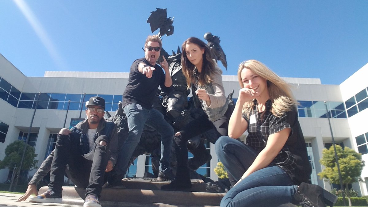 Malik, Alex, Michele, and Rachel pose in front of the Blizzard Orc statue on a sunny, clear day