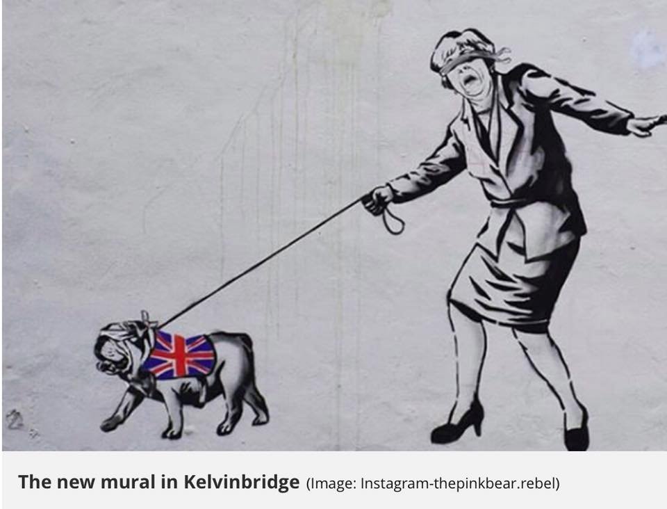 A Bankski style mural of a blindfold Theresa May being pull along by a British Bulldog