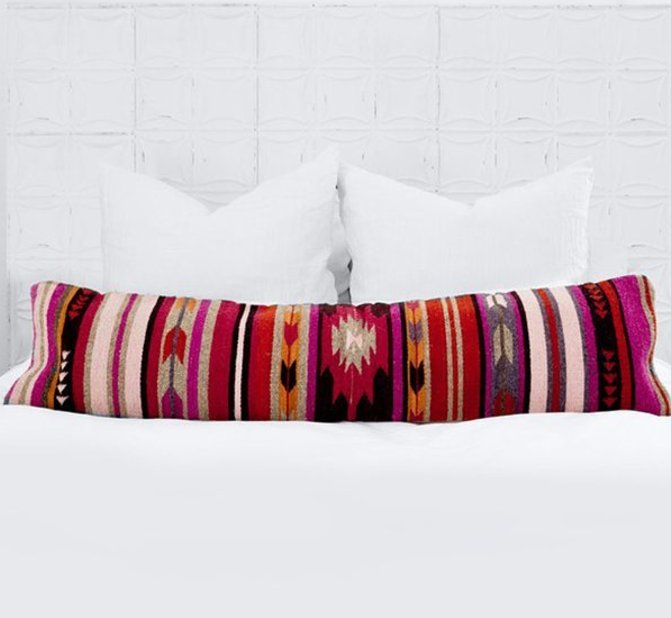 Throw pillows aren't your only option for a pop of color on white linens! Opt for a stylish lumbar pillow instead. https://goo.gl/919vPl