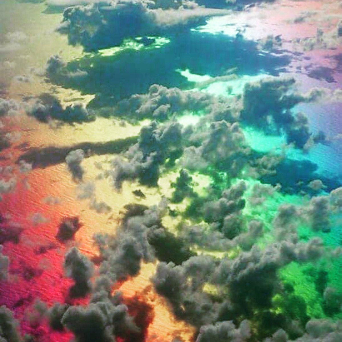 RichardDebs's tweet photo. Apparently a pilot took this picture while flying through a rainbow. Absolutely gorgeous!!!! https://t.co/emRpG7rnNe