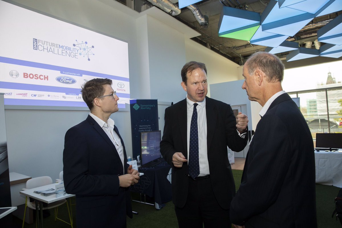 SMMT's tweet photo. Future Mobility Minister @Jesse_Norman talks to exhibitors at the SMMT #FutureMobilityChallenge about their automotive innovation and mobility solutions https://t.co/piIiN4qh0t https://t.co/wCRjNVQ2rZ