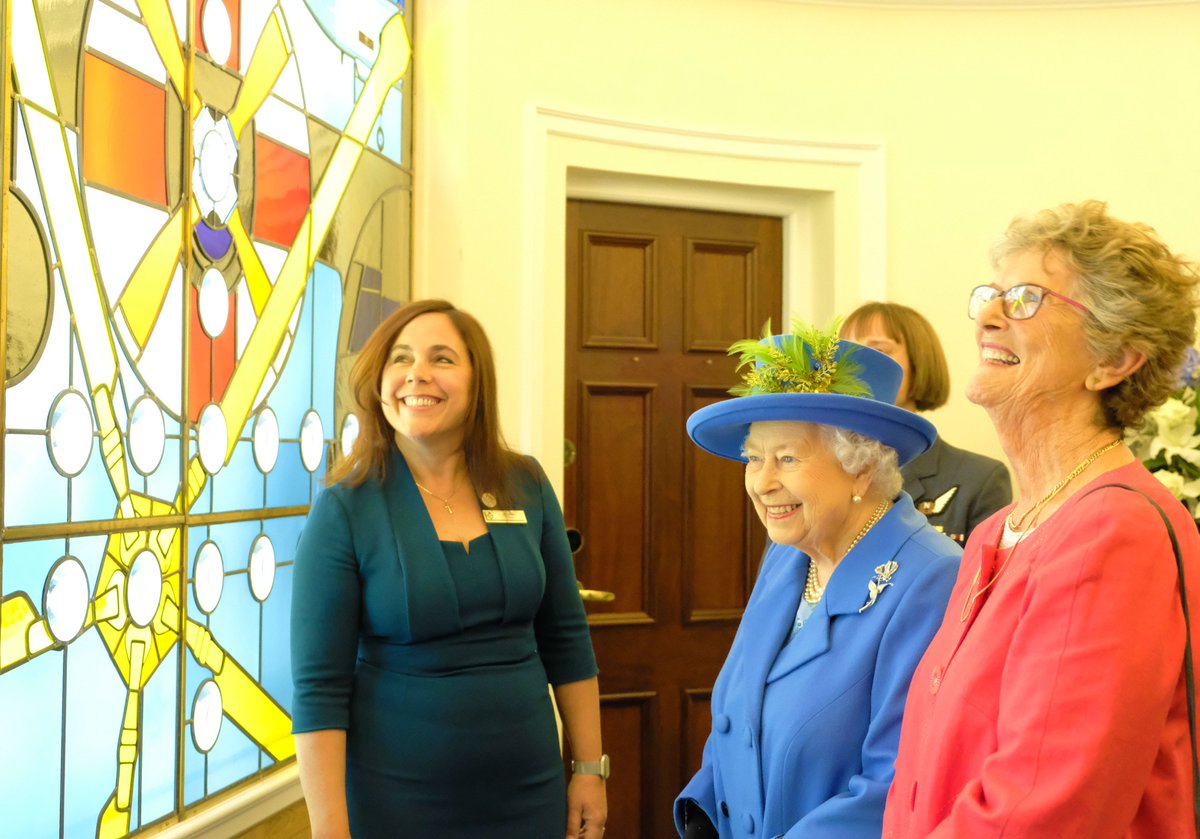 Jo Salter - Britain's first female fast jet pilot, who flew with 617 Squadron – shows The Queen a new stained glass window. Designed by Helen Whittaker, the window commemorates the role of women in the <a href="/RoyalAirForce/">Royal Air Force</a>.