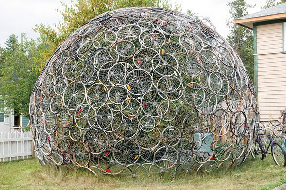 Artist in Whitehorse, Yukon, developed a spherical  art work constructed structure from wheels of various sizes that are bound together with plastic cable-ties. The interior is inhabited by a large birch tree &amp; is accessible through a rim, with no spokes.(ow.ly/hipU30mgGPp)