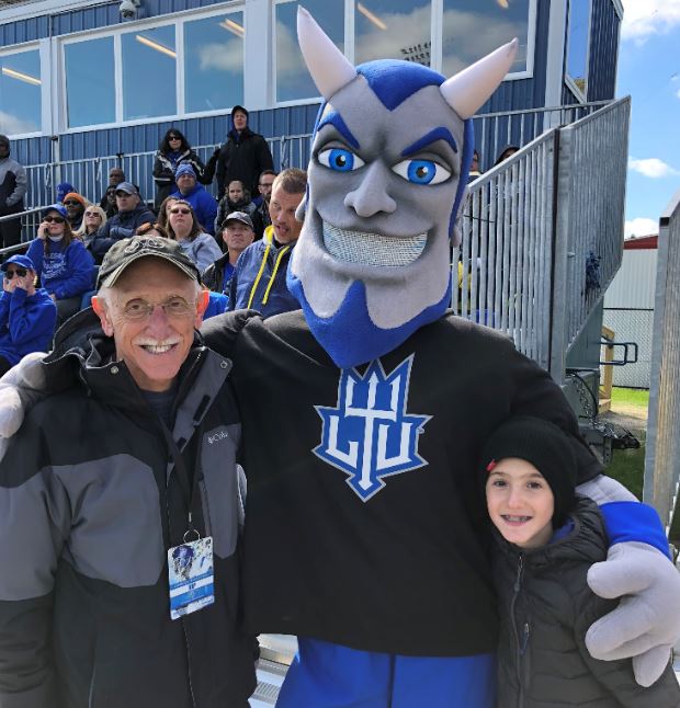 LawrenceTechU's tweet photo. Football brought much excitement to #campus this fall. Ely Tama '69 is pictured here with @BlueLawrence32 + his grandson at the #Homecoming game on 10/13 #LTUHC @LTUalumni #eLiTeU https://t.co/CbYRk4EBln