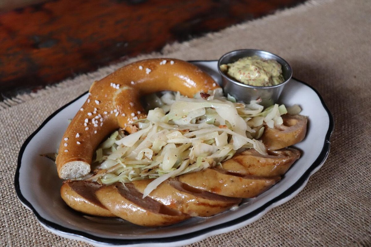 Sausage and Krautz. Served hiuse made Sauerkraut, Pretzel, and Mustard.