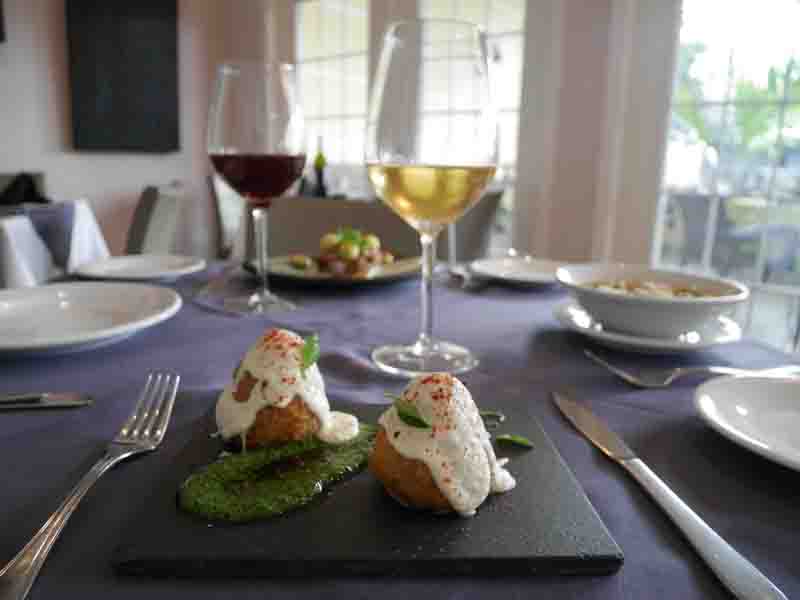 Estos tentadores arancini, bañados en salsa de queso y pesto, son parte de los nuevos platos de nuestra carta