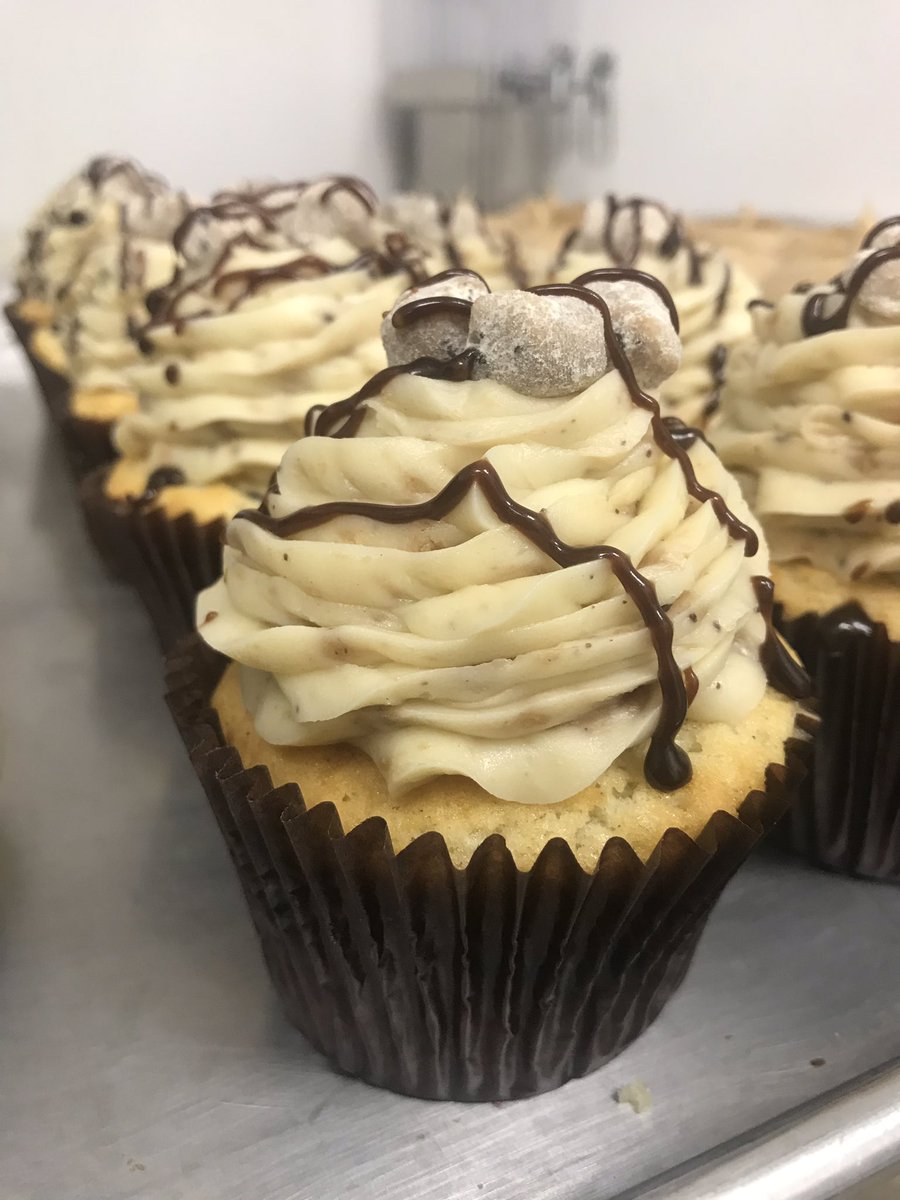 Cookie Dough is a vanilla chocolate chip cake topped with a cream cheese icing that has been infused with chocolate chip cookie dough, drizzles of chocolate fudge, and extra cookie dough pieces!