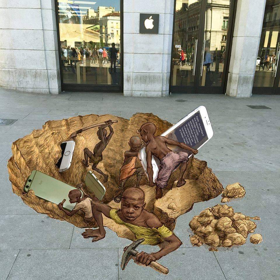 BlkHistStudies's tweet photo. #BreakTheSilence Edouardo Relero's 3D #StreetArt outside an #AppleStore in #Spain. A reminder that these are the people/children bringing you all those fancy phones from the mines of #Congo. Your technology wouldn't exist in its current advanced stage without #Coltan from Congo. https://t.co/pOPk1Mpsib