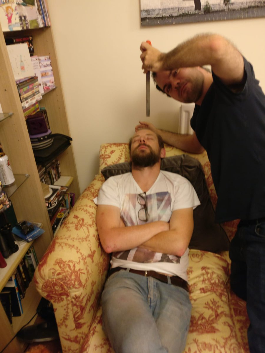 whoshotfirstdev's tweet photo. Happy Sunday twitter peeps can't think of anything constructive to post so here's a picture of our  writer and game director @GlennBunn trying to shiv me whilst I'm asleep. #withfriendslikethese #sleepy #gamedevs #IndieDev #Halloween #indiegamedev https://t.co/y0zGx3A1mS