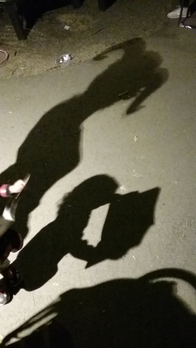 Went to a family halloween event at the local zoo tonight. Here's <a href="/TheGoblinGal/">Bethany Leino Davis</a> standing behind our daughter looking at a coloring book. Their shadows gave me a labyrinth type vibe. #halloween