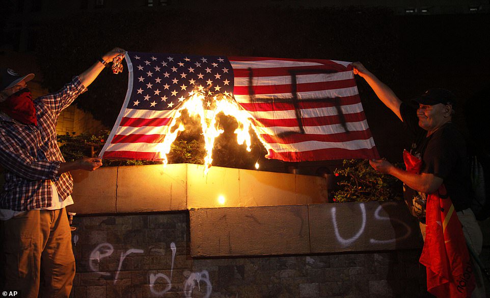 Coming for a 'better life': caravan illegals paint swastika on American flag then burn it