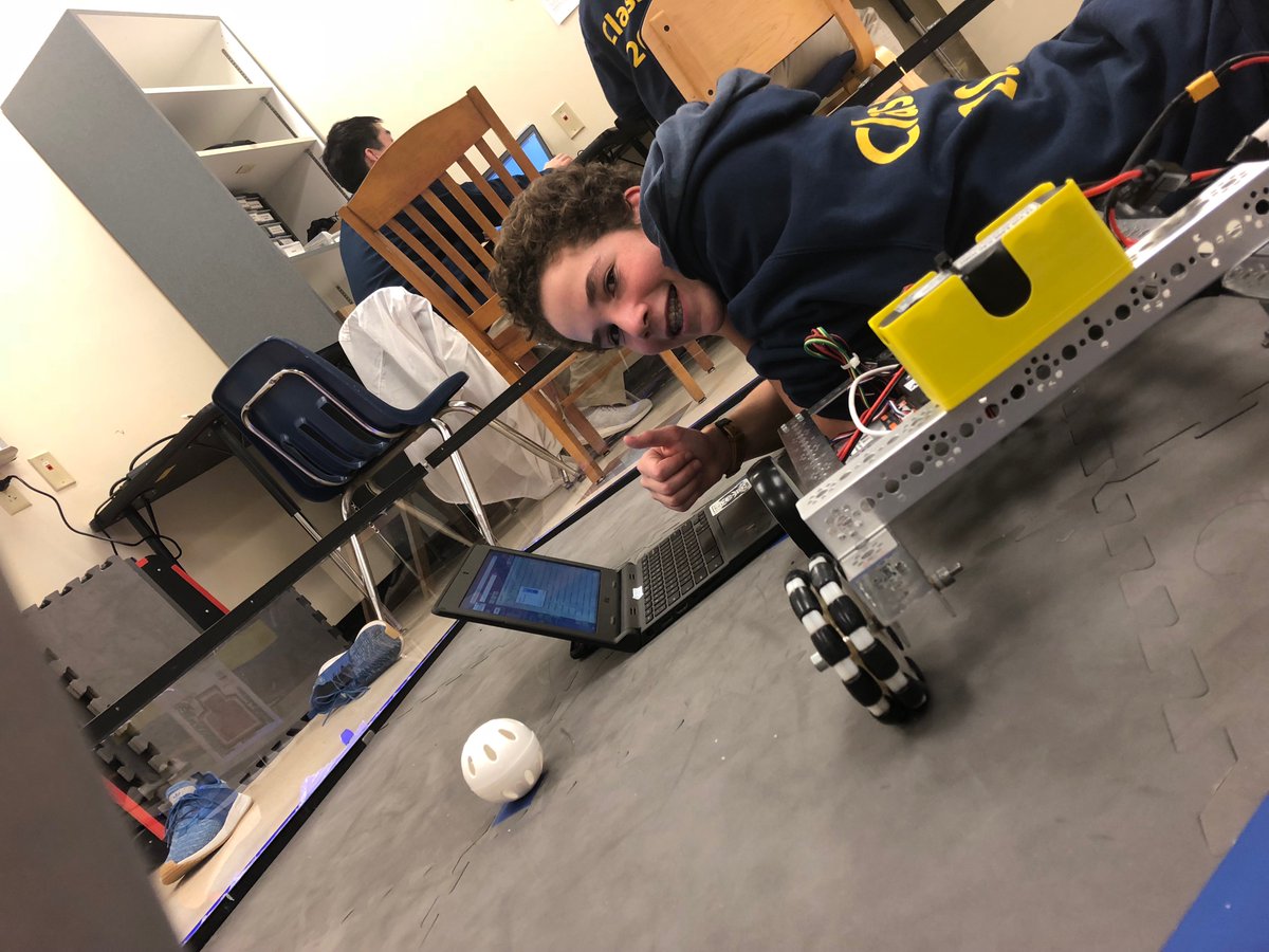 In this picture, Jack from the programming team is working on our robot and its color sensor.