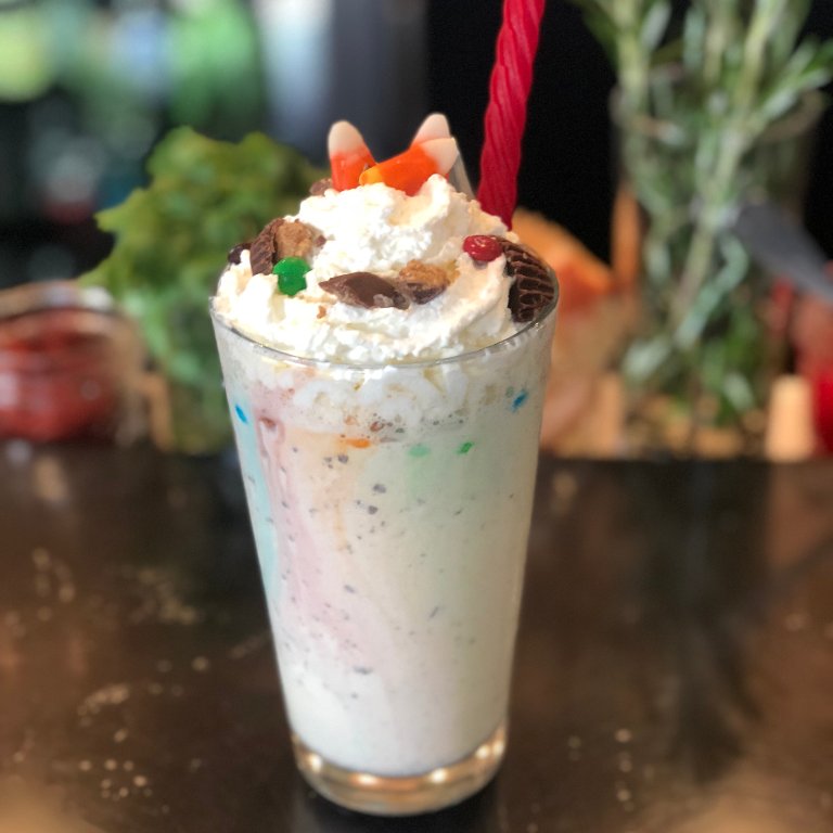 Trick or treat, give me this shake to eat!! Have you had this month’s milkshake yet? Just a few days left on this delightfully decadent Halloween treat complete with candy corn &amp; a red vine straw. It's waiting for you in the Coffeehouse...