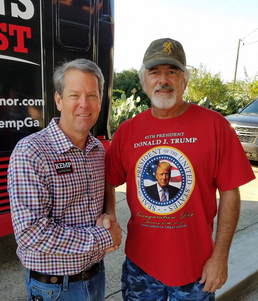 John C. Hall with Brian Kemp earlier this year.