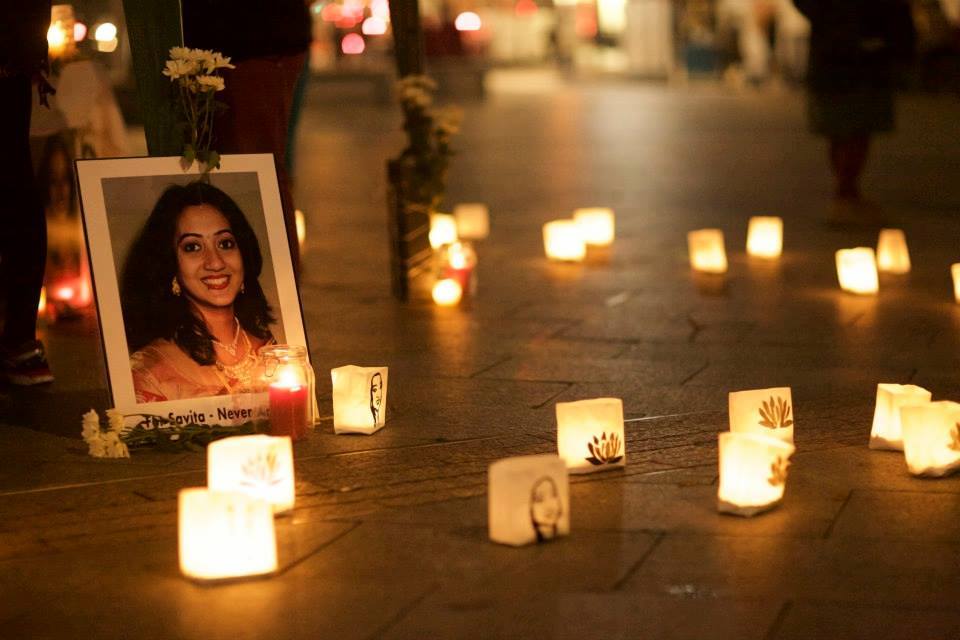 Photo of a candlelit vigil in memory of Savita Halappanavar, with a number of candles on the ground surrounding a portrait of Savita. Photo credit: Joe O'Shaughnessy