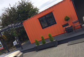 One of our very funky buildings complete with deckins and pot plants! #portableaccommodation #orange #manyuses #newspace #containerproject #socialhousing #affordablehousing #onebedroom