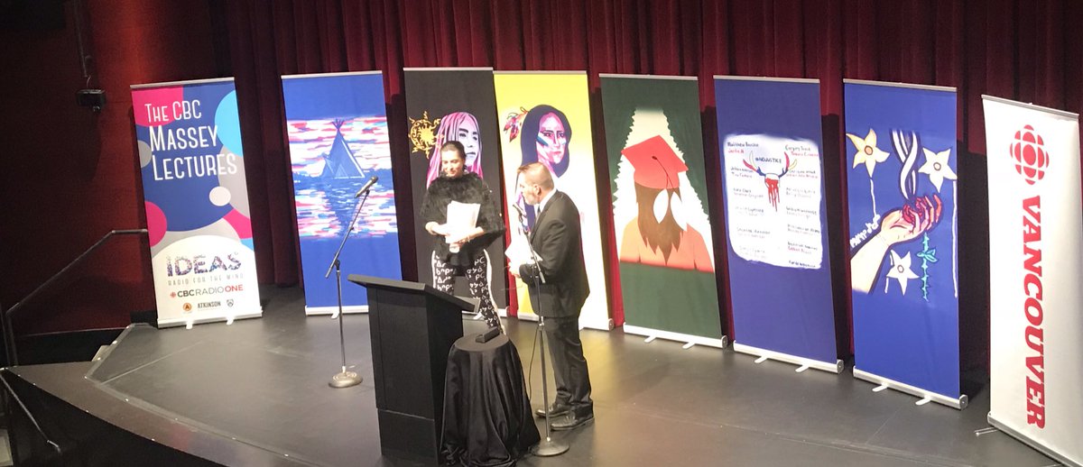 drawing_change's tweet photo. Tanya Talaga is this year’s #masseylectures. 
on stage with beautiful artwork made by Indigenous youth behind her - she says in this way, she is never alone. It’s a way to make visible the belonging and resilient, Indigenous cultural continuity that she speaks of. https://t.co/osp6UF1ey2