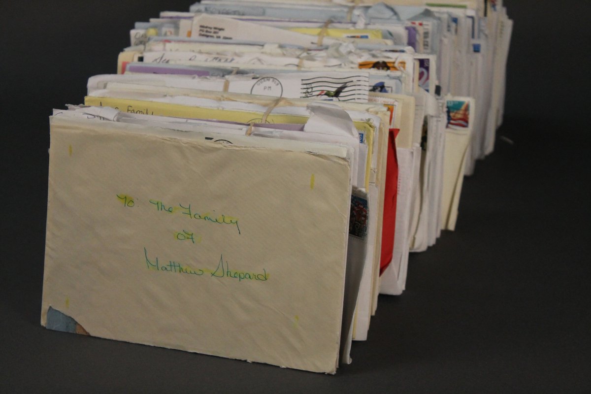 A large stack of letters, cards, and messages, tightly packed and neatly organized.
