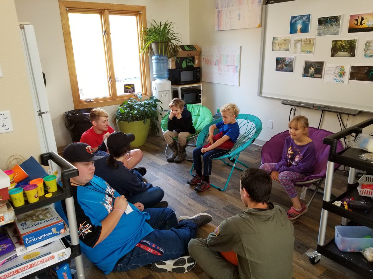 SchoolInnovate's tweet photo. Student teaching students joined us today for pumpkin carving and stories. The kids sit in chairs while the young adults end up on the floor! #TISValues #Passions #ConfidentKids https://t.co/pYHg0A3Bkq