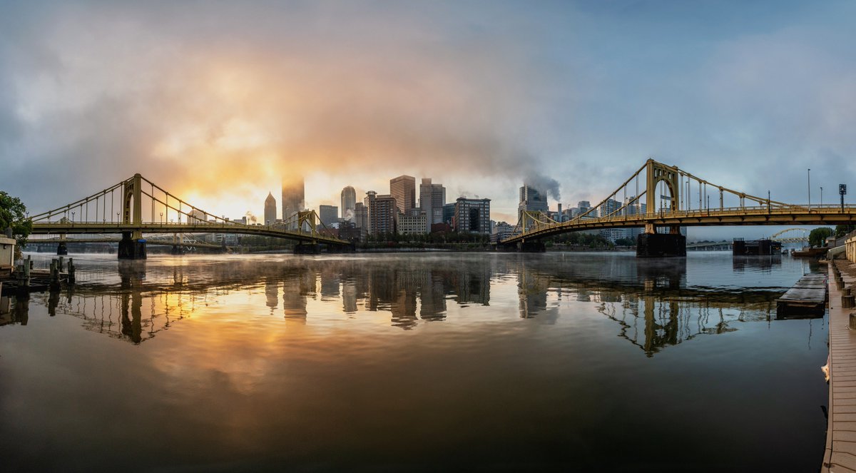 DaveDiCello's tweet image. An 8 image panorama from the banks of the Allegheny River on a foggy morning in #Pittsburgh, as the rising sun illuminated the low hanging fog with a beautiful golden glow just after sunrise. The river was just still enough to provide a decent reflection of the city as well.