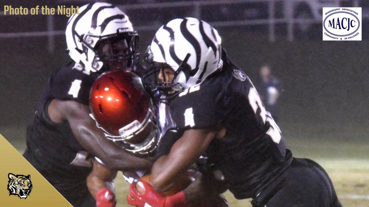 NEMCCTigers's tweet photo. FB | PHOTO OF THE NIGHT: In the middle of a consistent rain, which lasted all game long, #NEMCC sophomores Chrishun Jackson &amp; Jeremiah Boyd combine for this hard-hitting tackle on an East Mississippi player! #TigerPower https://t.co/eOuSf52nqm