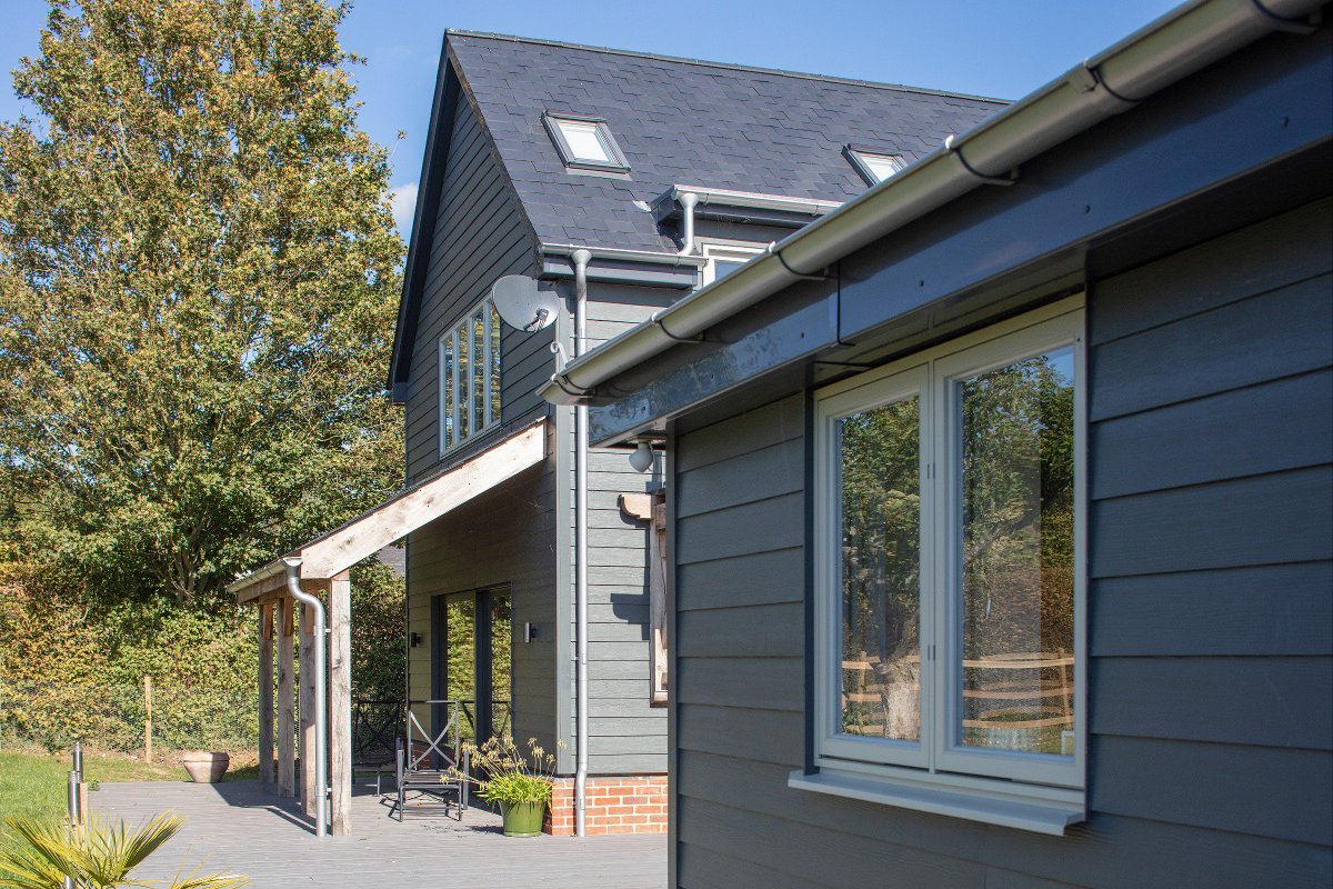 Check out this beautiful new luxury detached home in #Cambridgeshire. The home is clad in iron grey cedar HardiePlank®, used in a three quarter wrap with red brick, with a traditional ship lap weatherboard effect to complement local architectural styles. #UKproperty #cladding