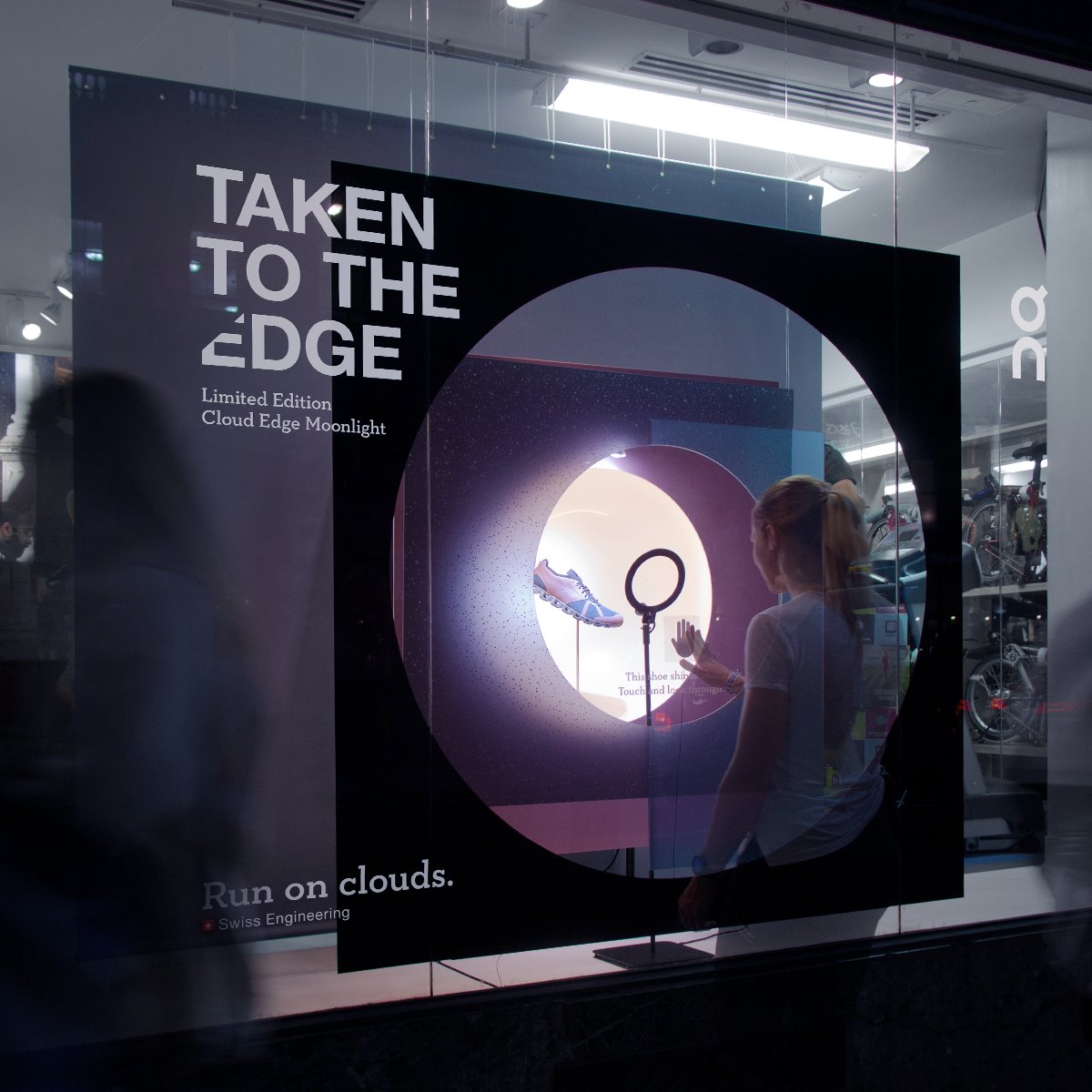 on_running's tweet photo. The limited edition Cloud Edge Moonlight lands at @RunnersNeed London, illuminating urban explorations of passers-by. Touch the window, and see how the shoe lights up your city adventures! Discover the shoe: https://t.co/8E2oic0bWE https://t.co/4BdCghbWvc