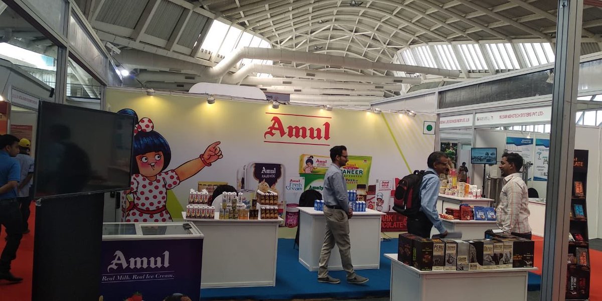 Team interacts with the representatives from <a href="/Amul_Coop/">Amul.coop</a> at the #IUFoST2018 Food Expo and enjoy sampling Lactose free milk &amp; Venezuela ebony twist dark chocolate!! Come, visit now for more! #Day5 #LastDay
