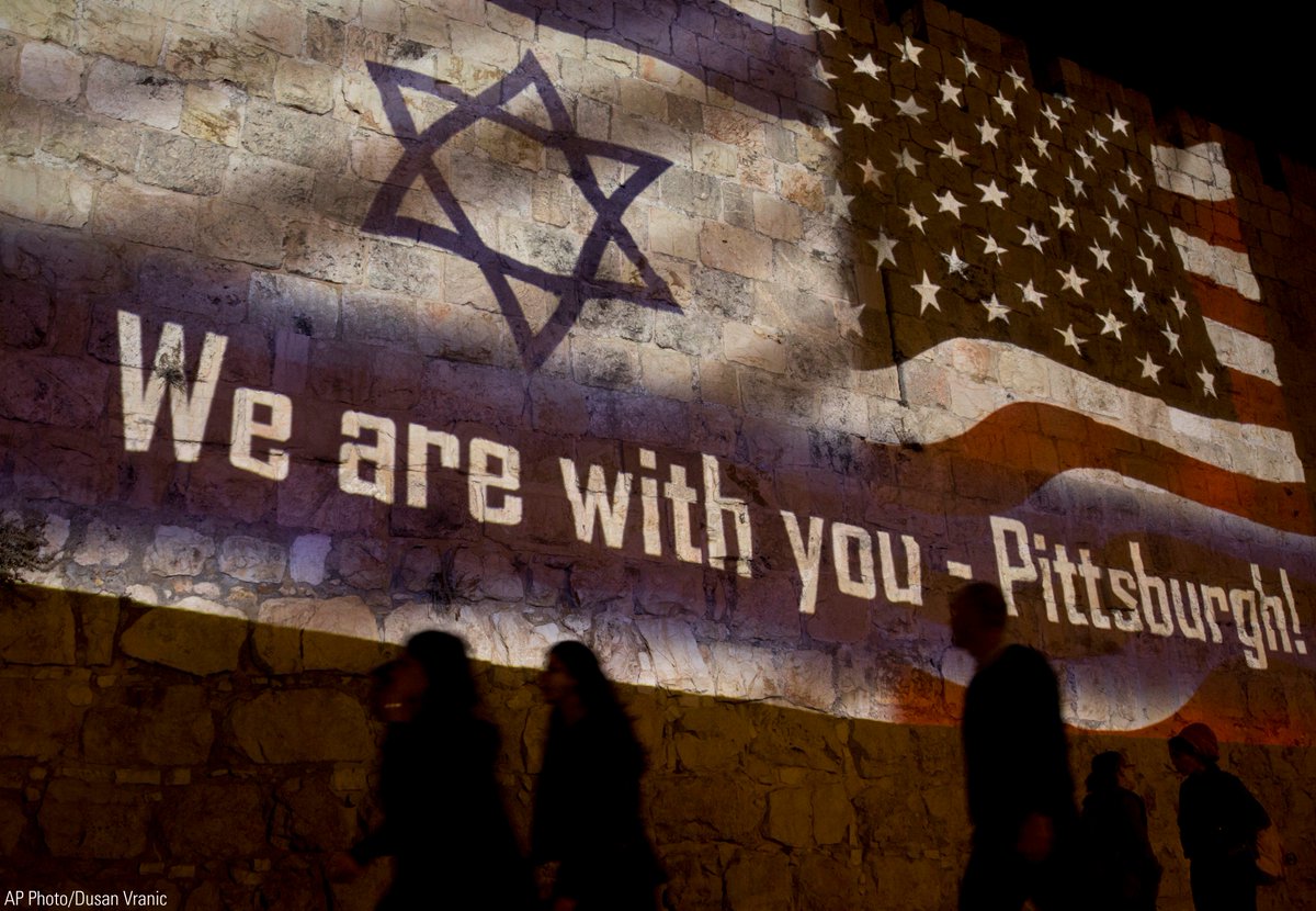 FoxNews's tweet photo. People walk past a projection on the Old City wall in Jerusalem, Sunday, Oct. 28, 2018 in a commemoration of the victims of a deadly shooting at a Pittsburgh synagogue. https://t.co/cIZIbqME25 https://t.co/kIKmfoaV7U