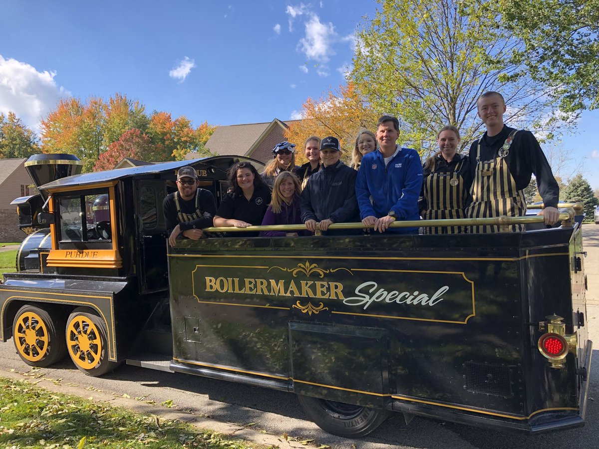 Kat9798's tweet photo. What a fun surprise today!!! Heard The Boilermaker Special 🚂 coming down the street before we saw it!  Tyler was honored and presented with the inaugural Spirit of Purdue Award by the Purdue Reamer Club!💛🖤💛🖤 Grateful! @theTylerTrent @PurdueTrain @ReamerClub https://t.co/J9Mtqna2PC