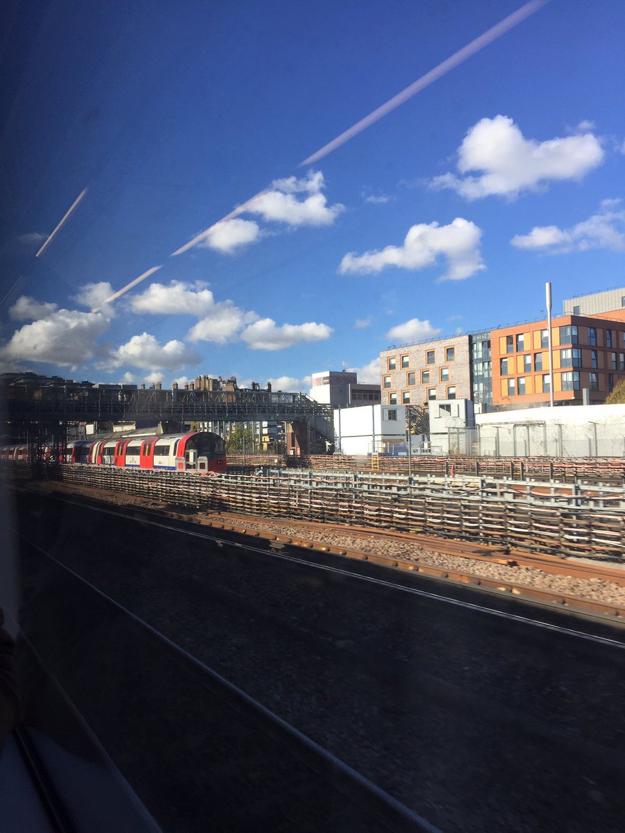 ErinSpinney's tweet image. Jubilee Line train pulling in to West Hampstead and the Metropolitan Railway bridge #viewsfromtrains #prettyclouds