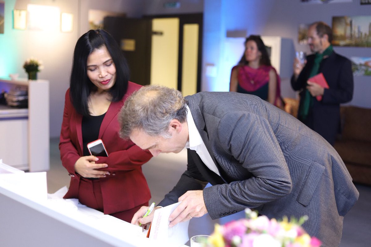 diArchitects's tweet photo. Lucio Guerra (COO), next to Berna Medina (Dubai Office Manager), signing a book for one of our guests #designinternational #dubai #motionbuildingsmeetingplaces #book #architects https://t.co/9rmIHW0d2o