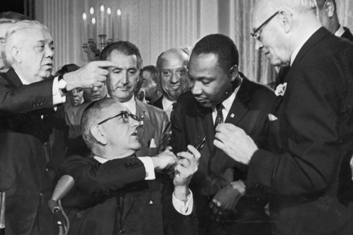 When he became president in 1963, LBJ took the civil rights bill that JFK had introduced, making it a lot stronger in several key provisions and then using every effort to push it through Congress.Here he is signing the Civil Rights Act of 1964 with MLK Jr.