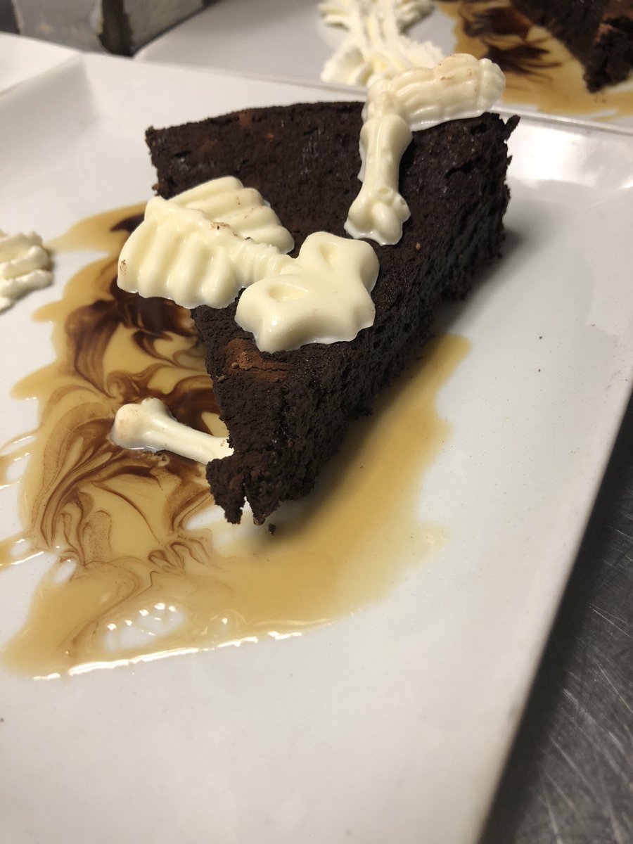 Oh damn. Dessert special this week is flourless chocolate cake with white chocolate bones and caramel drizzle! #eldoradocafeatx #halloweendessert