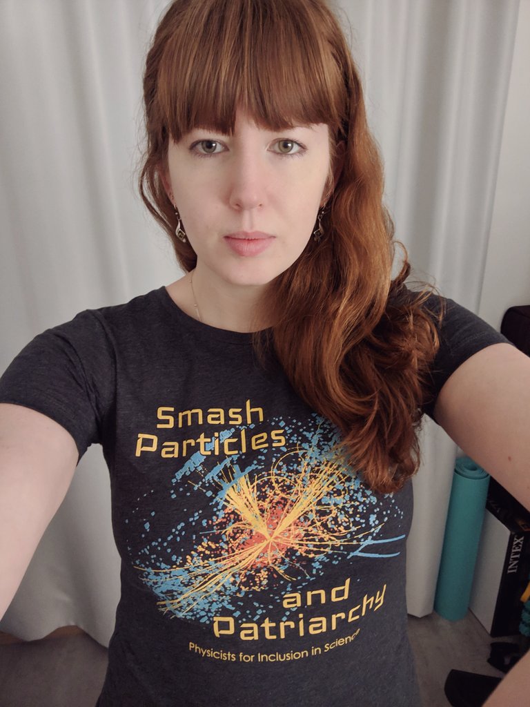 Picture of me in a t-shirt which says: "Smash particles and patriarchy. Physicists for inclusion in science".